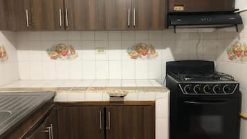 Fridge, stovetop, cookware/dishes/utensils, dining tables