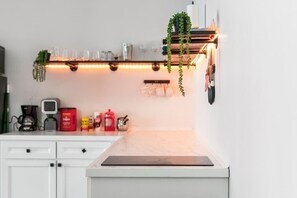 Fridge, microwave, coffee/tea maker, cookware/dishes/utensils