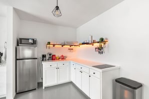 Fridge, microwave, coffee/tea maker, cookware/dishes/utensils