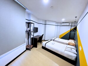 A compact hotel room with a bed, a desk, a chair, a television, and a small shelf. - Seeds Hotel Cheras Sri Permaisuri (Kuala Lumpur)