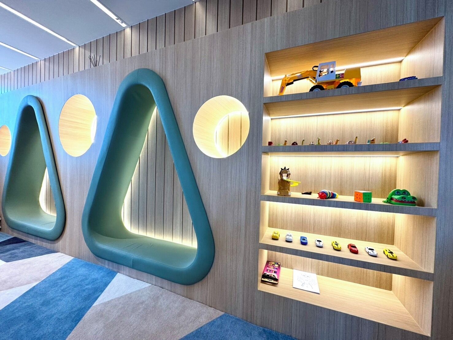 A modern interior with unique seating and shelves displaying toys and figurines.