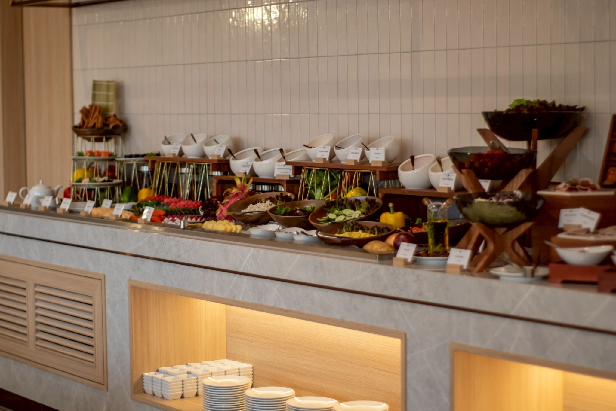 A buffet setup with various food items and serving utensils.