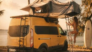 A yellow van parked on a sandy beach with a canopy, a surfboard, and a ladder. - VAN Longani (Le Tampon)