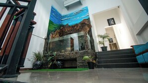 A staircase with a stone wall and a glass enclosure.