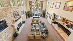 A spacious living room with a fireplace, a dining area, and a kitchen. - South Reno 1BR · Near Reno Events, Pool & Gym (Reno)