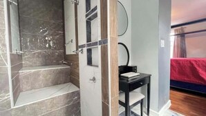 A bathroom with a marble shower, a sink, and a mirror. - Spacious DC Getaway • Modern Comfort • Walk-In Shower • Near Metro (Washington)