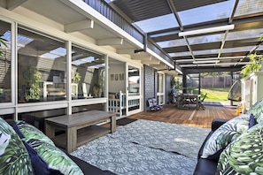 Relax in a serene outdoor space with a wooden deck, patio, and comfortable seating.