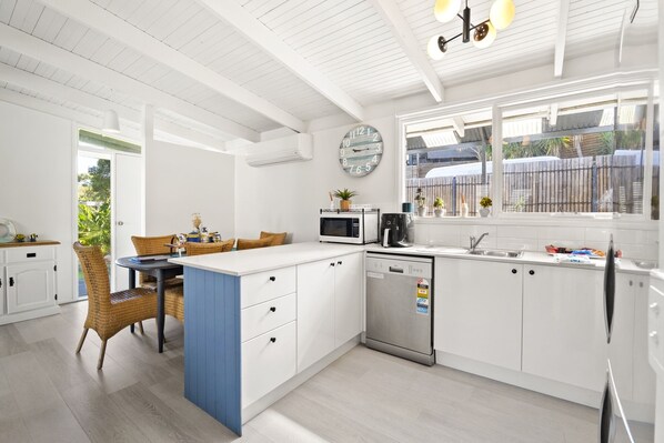 Enjoy meals in the kitchen with a dining area and modern appliances.