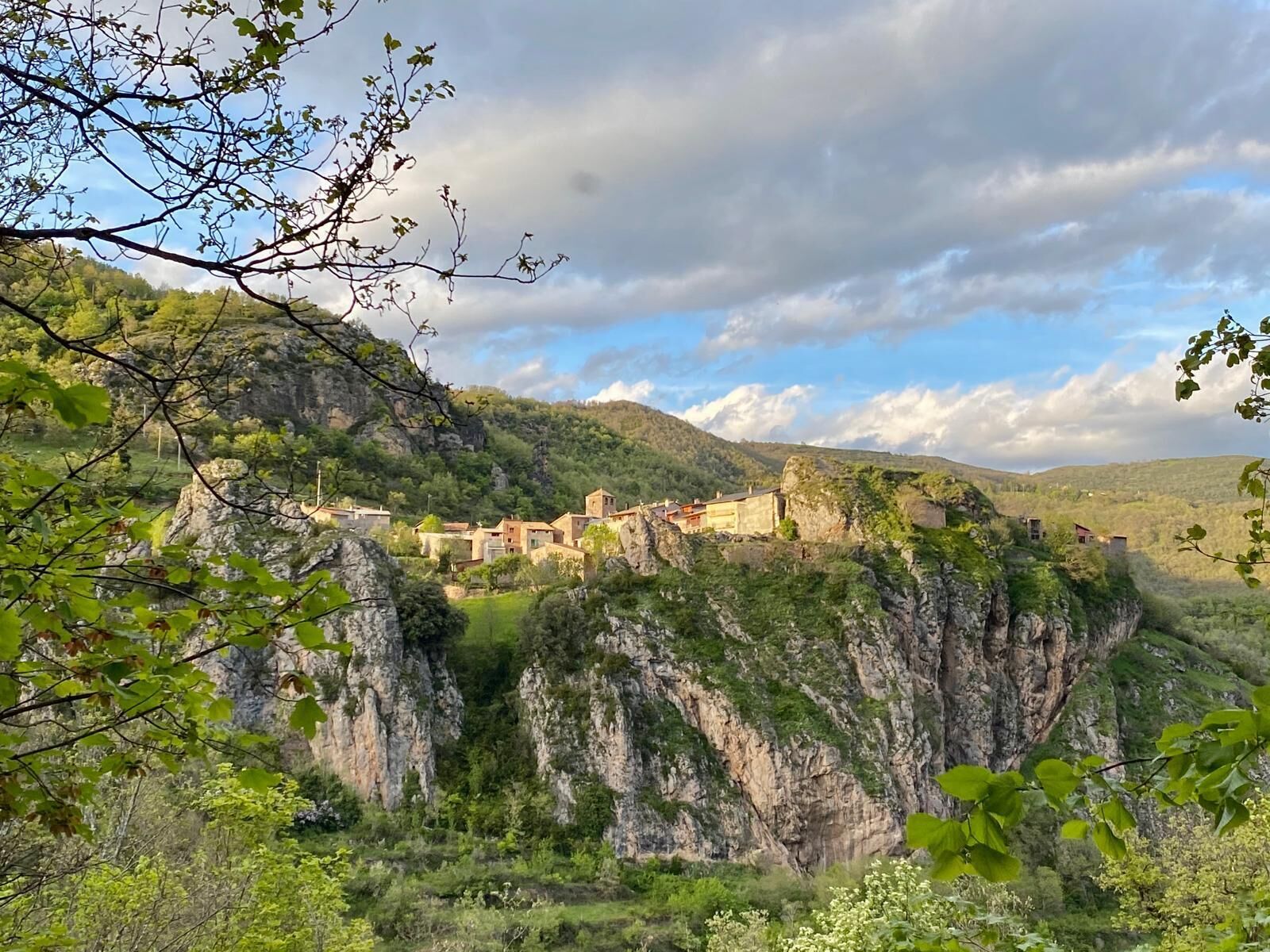 A mountainous village with buildings nestled among rocky cliffs.