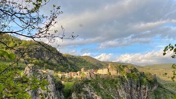 A mountainous village with buildings nestled among rocky cliffs.