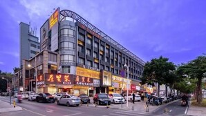 A multi-story commercial building with various storefronts and a parking lot. - Yuan Culture Hotel Shenzhen (Shenzhen)