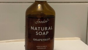 A bottle of Foeder Natural Soap Grapefruit on a white surface.
