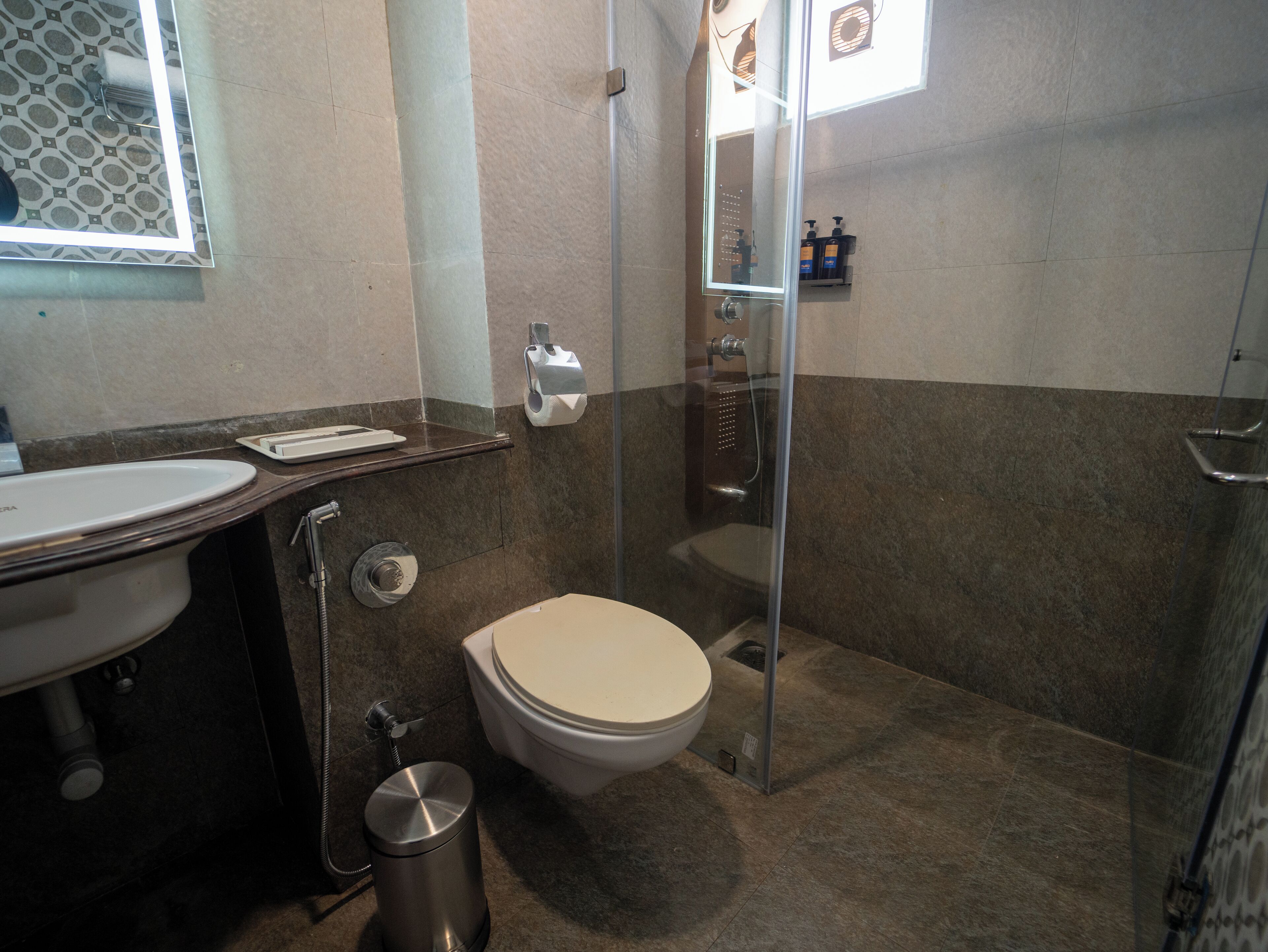 A bathroom with a toilet, sink, and shower.