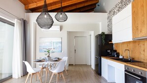 A modern kitchen with white cabinets, a wooden countertop, and a black refrigerator. - Scenic villa in Rethymno with private pool (Rethymno)