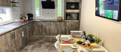 A modern kitchen with a dining area set for a meal.