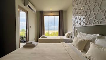 Family Triple Room, Sea View | In-room safe, desk, laptop workspace, soundproofing