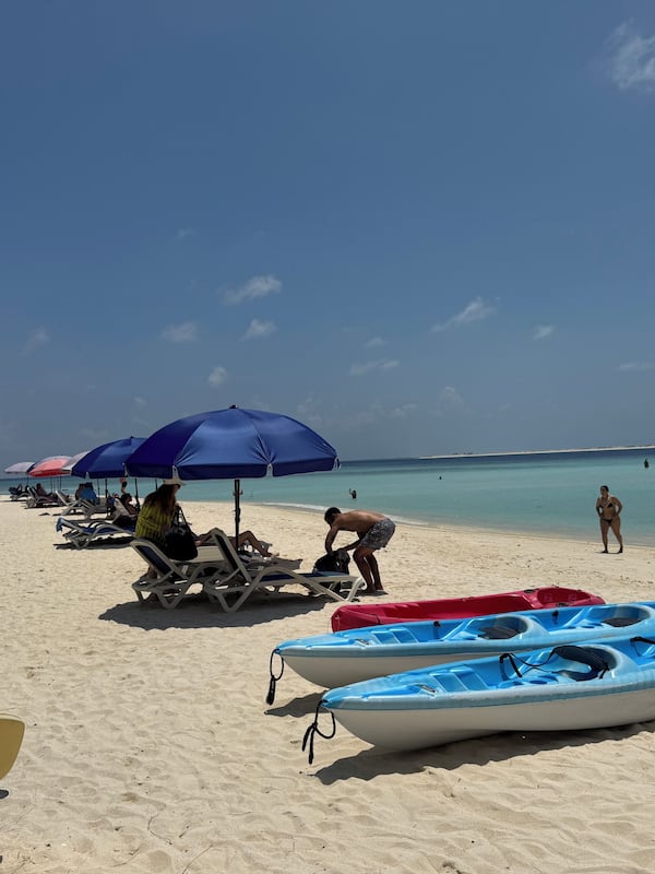 On the beach, beach umbrellas, beach towels, beach volleyball