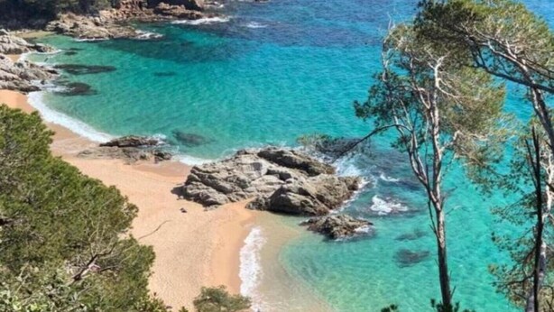 A coastal landscape with clear turquoise waters, rocky outcrops, and a sandy beach. - Villa on Costa Brava with Pool & Sea Views (Lloret de Mar)