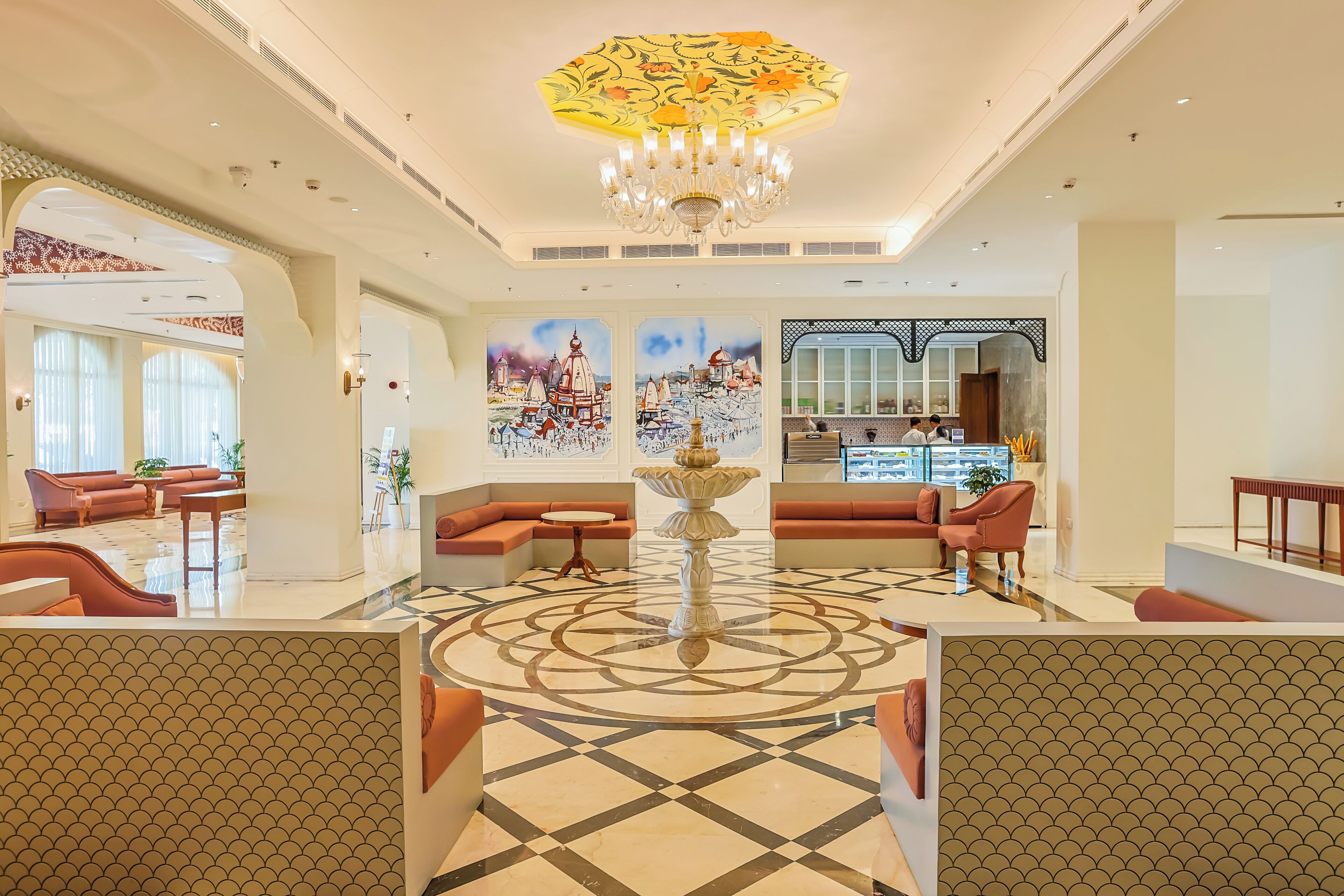 A spacious lobby with a central fountain, seating areas, and artwork on the walls.
