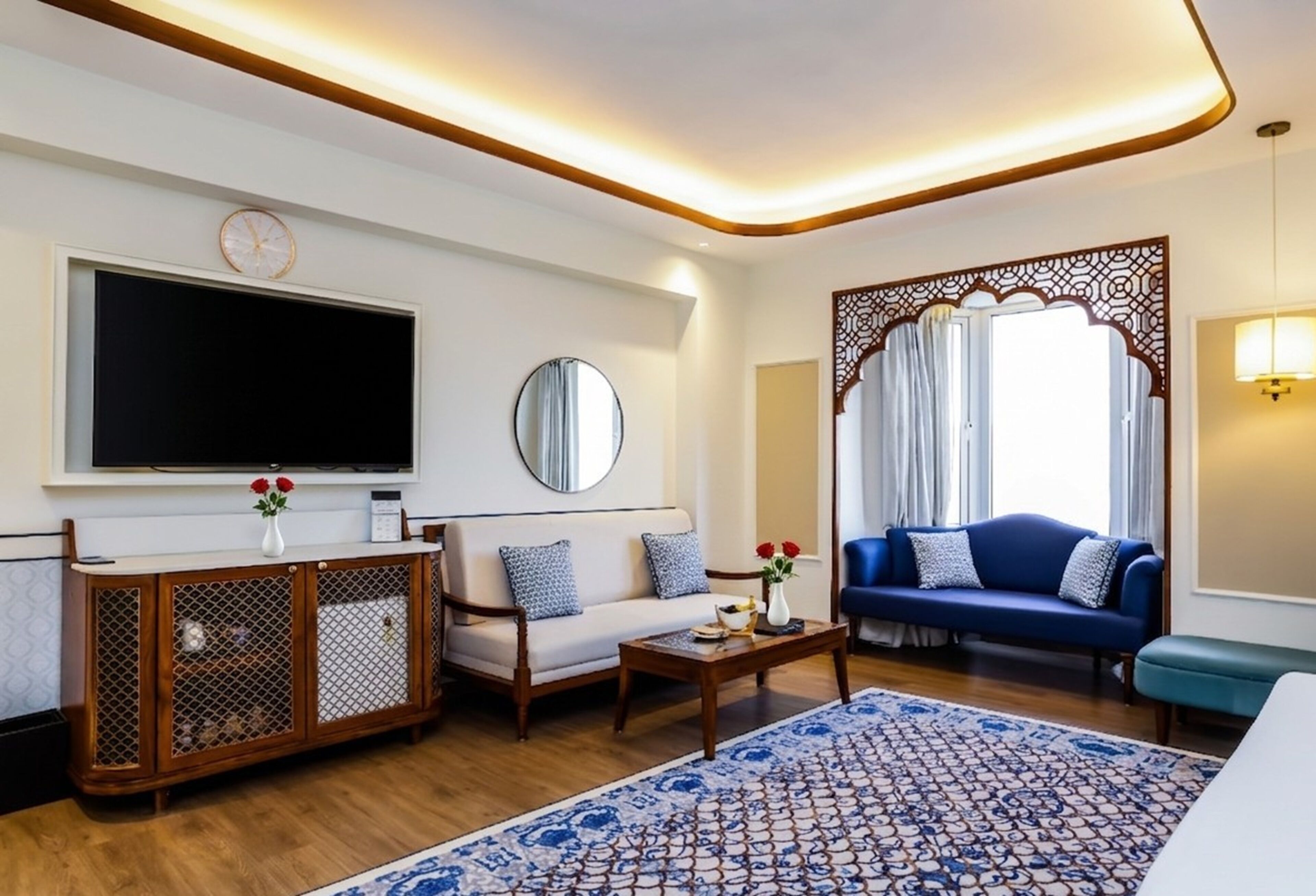 A living room with a TV, sofa, coffee table, and decorative items.