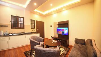 Deluxe Apartment, Non Smoking, Corner | Living area | Flat-screen TV
