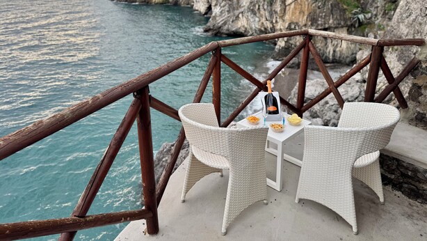 A seaside terrace with wicker furniture, a bottle of champagne, and snacks. - Villa Ravello - beach (ravello)