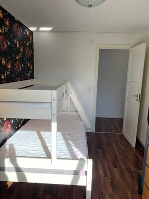 A room with a bunk bed, a door, and a wall with a space-themed mural. - Ronneby Torneryd Retreat (Ronneby)