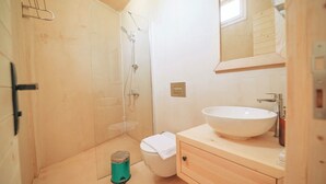 A small bathroom with a shower, toilet, and sink. - Felix Rooms (Marmaris)