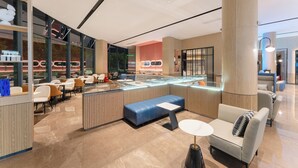 A modern interior with seating areas, a counter, and large windows. - Echarm Hotel Guangzhou Baiyun International Airport T3 Terminal Branch (Guangzhou)
