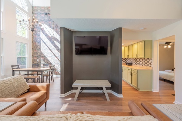Sunlit living room with smart TV and modern accent wall — perfect for movie nights.