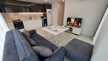 Deluxe Condo, Balcony, Sea View | Living area | Flat-screen TV