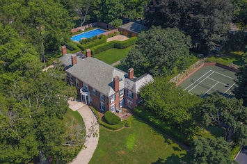 Elegant estate featuring a private pool, full tennis court, and beautifully manicured grounds. Perfect for family getaways or group retreats with plenty of space to relax and entertain.