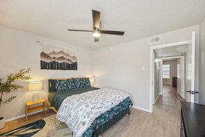A bedroom with a bed, bedside table, lamp, and a ceiling fan. - The Landry 174 | Spacious and Cozy 2 Bedroom 2 bth (Arlington)