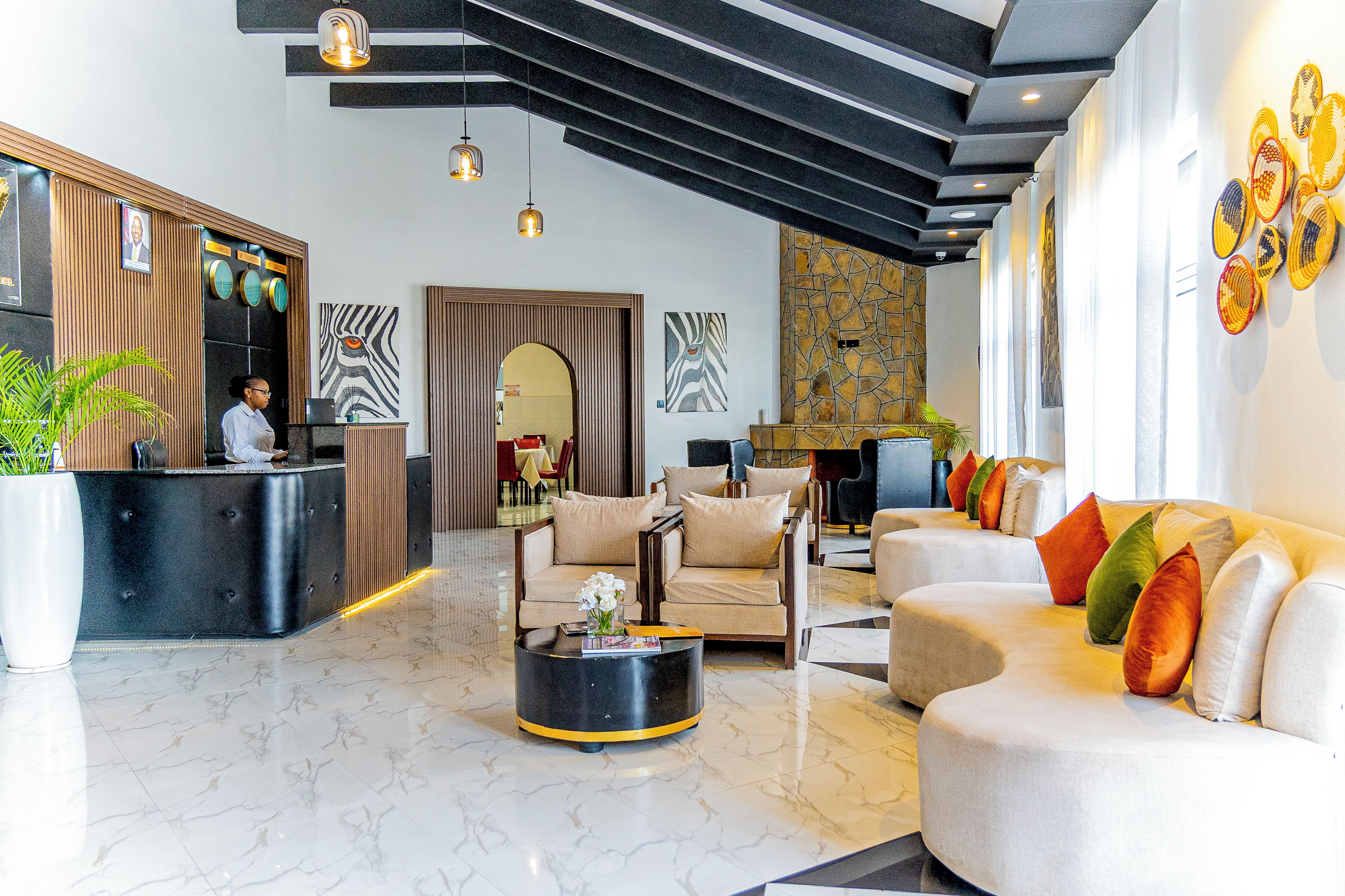 A modern lobby with a reception desk, seating area, and a stone accent wall.