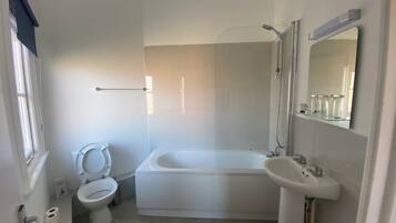 Bathroom features a toilet, bathtub, and sink.
