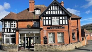 A traditional Tudor-style building with a sign reading "Stokesay Inn". - Stokesay inn and b and b  (Craven Arms)