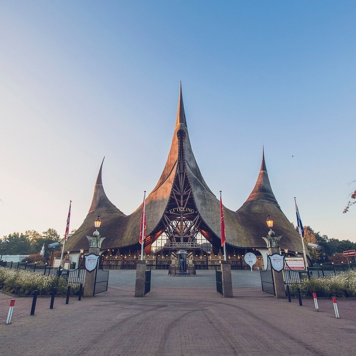 A large, modern building with a unique, pointed roof structure.
