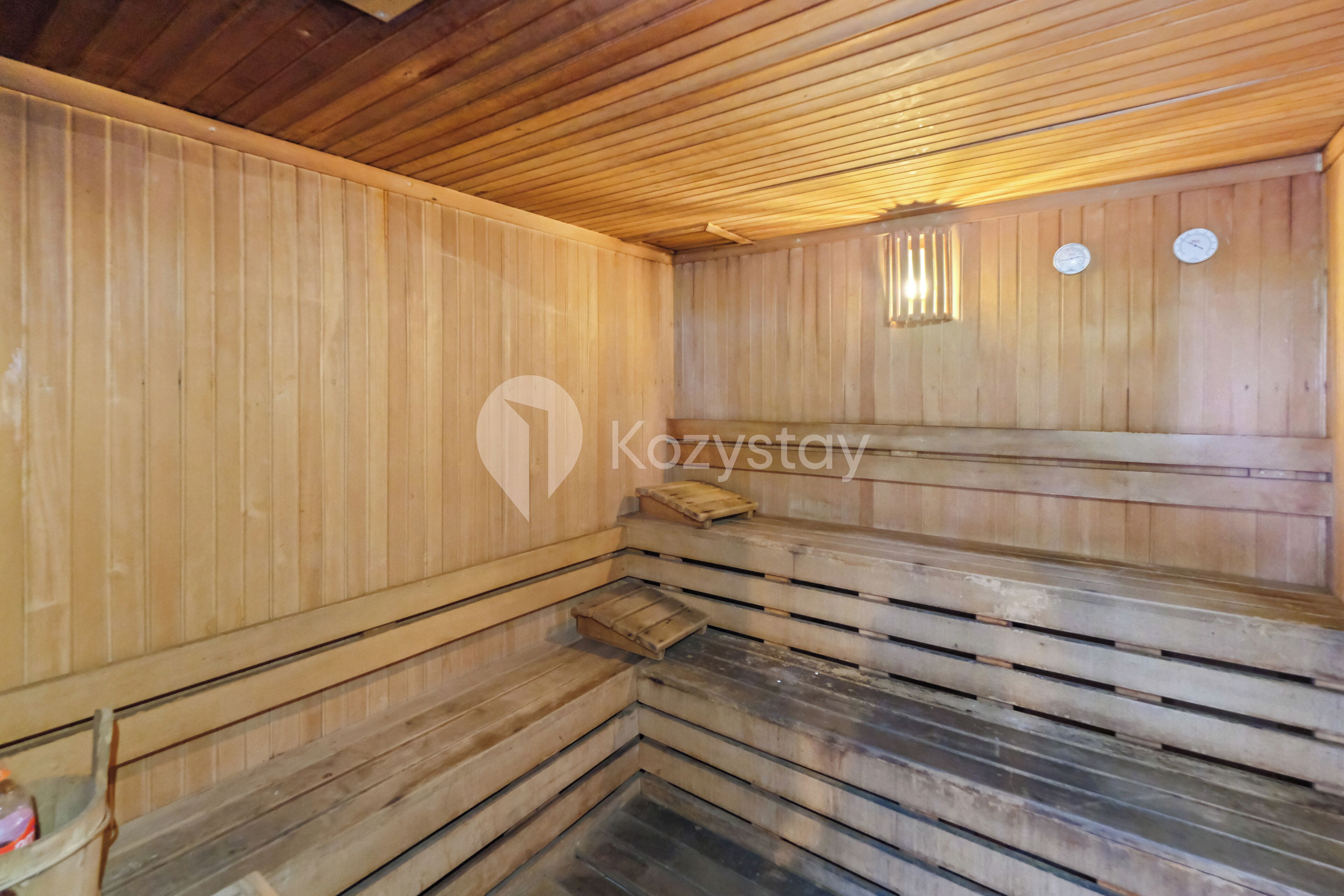 A wooden sauna with benches and a wooden ceiling.