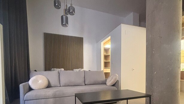 A modern living room with a grey sofa, a black coffee table, and a pendant light fixture. - SANTA ANA - SEASONAL RENTAL (Alicante (Alacant))