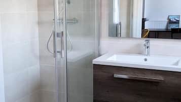 Shower, hair dryer, soap, toilet paper