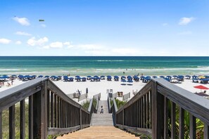 A wooden staircase leading to a beach with umbrellas and beach chairs. - 30A | 2 Mins to Beach | Private Pool & Beach! (Inlet Beach)