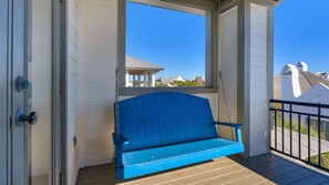 A blue bench on a wooden deck with a view of houses in the background. - 30A | 2 Mins to Beach | Private Pool & Beach! (Inlet Beach)