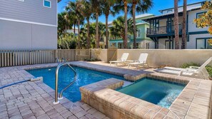 A swimming pool with a ladder, lounge chairs, and a wooden fence. - 30A | 2 Mins to Beach | Private Pool & Beach! (Inlet Beach)