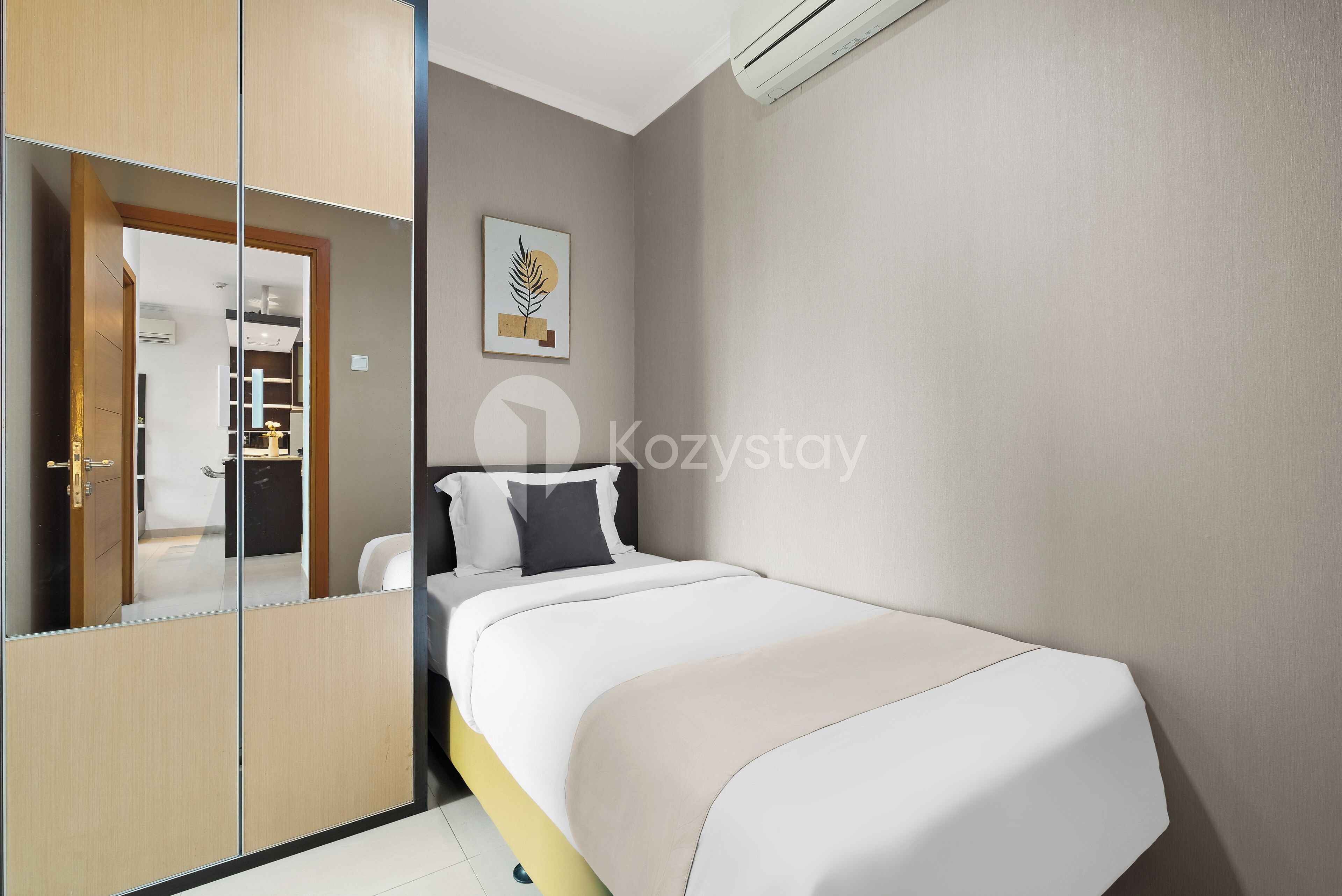 A modern bedroom with a bed, a wardrobe, and a mirror.