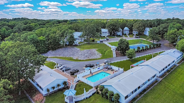 A large resort with multiple buildings, a swimming pool, and a well-maintained lawn. - Two Bedroom Harbor View Condo (Grand Rivers)
