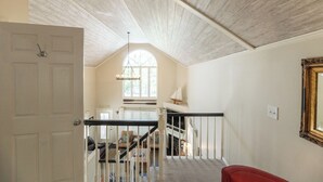 A staircase with white railings leading to a second floor.