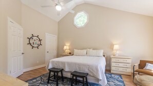 A bedroom with a bed, two nightstands, a desk, and a chair. - Four Bedroom 4.5 Bath Condo (Grand Rivers)