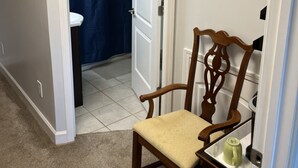 A room with a wooden chair, a small table with a green mug, and a white air conditioning unit. - Beautiful Room Just Waiting for You Pool IS Closed (Etowah)