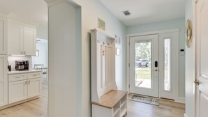 A modern kitchen with white cabinets, a wooden bench, and a coffee maker. - 5 Mi to Dtwn Beaufort: Home w/ Screened-in Patio (Port Royal)