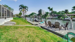 A waterfront patio with outdoor seating and a view of the water. - Centrally Located Cocoa Beach Haven: Walk to Shore (Cocoa Beach)